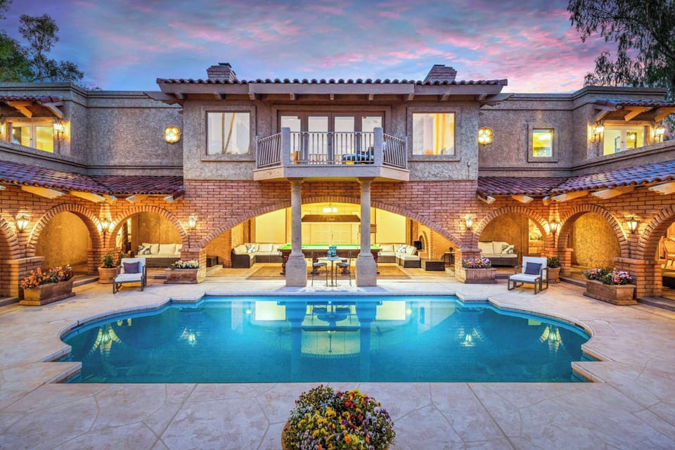 View upon arrival entering from the carport through giant French doors opening to the massive courtyard with the perfectly private walk-in Roman pool, snooker lounge and plenty of outdoor seating