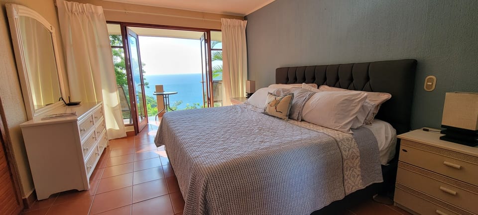master bedroom with ocean view and balcony
