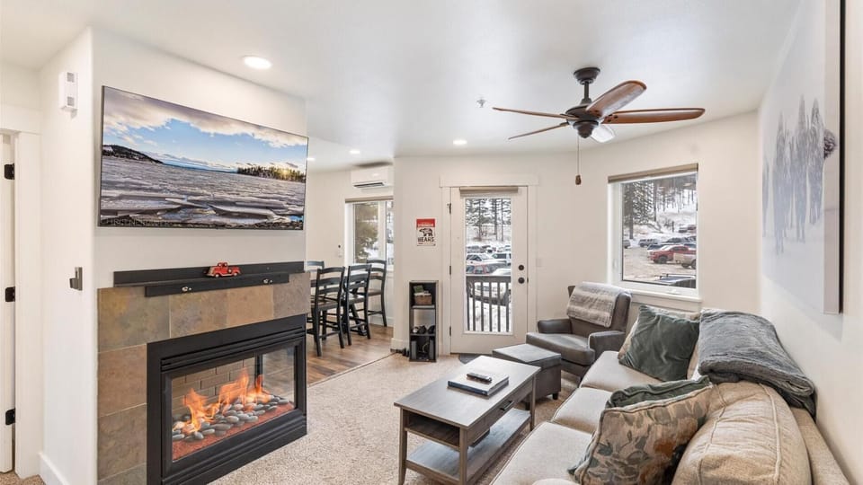 The newly updated open concept living area features a brand new fireplace, HDTV with streaming capabilities, and cozy seating after a day on the slopes.
