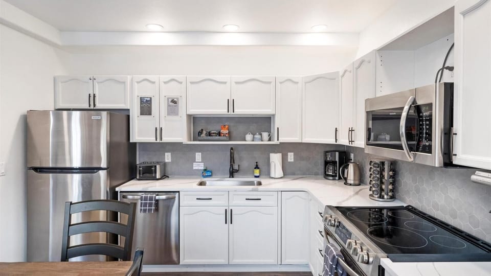 This newly remodeled chefs kitchen features brand new appliances, fully stocked with all the cookware and kitchen utensils.