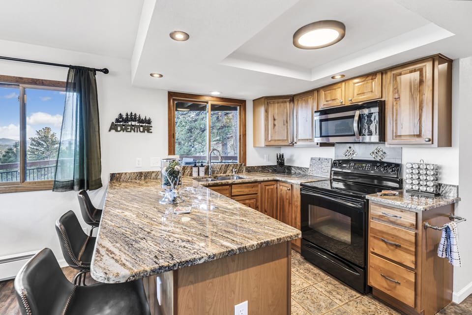 Fully stocked kitchen with spices, cooking ware, utensils and appliances.