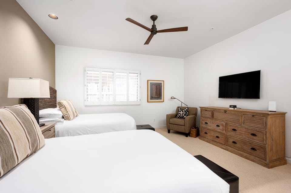 Two Queen beds with a private seating area.