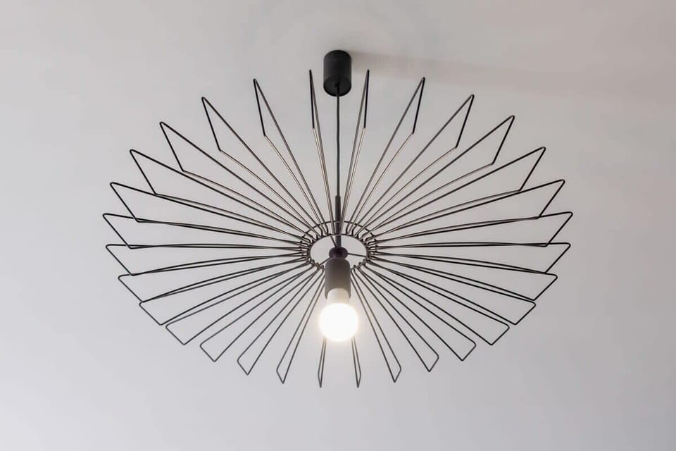 A unique chandelier with an artistic design, adding character to the living space.
