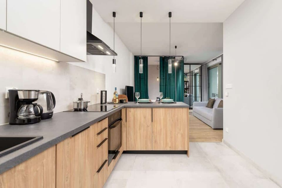 Another angle of the kitchen, highlighting its modern appliances and ample workspace.
