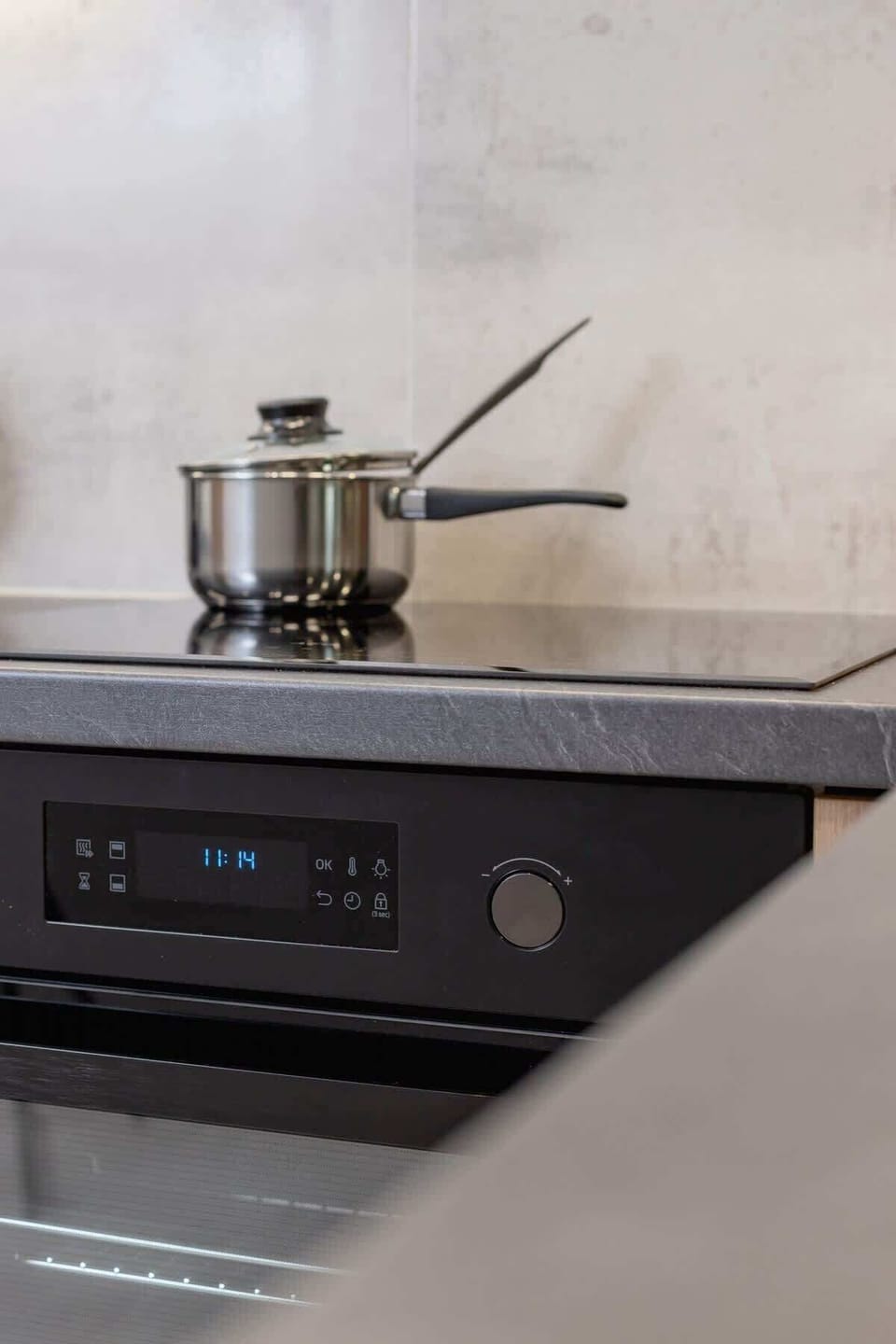 A close-up of the kitchen stove, illustrating the clean and practical design.
