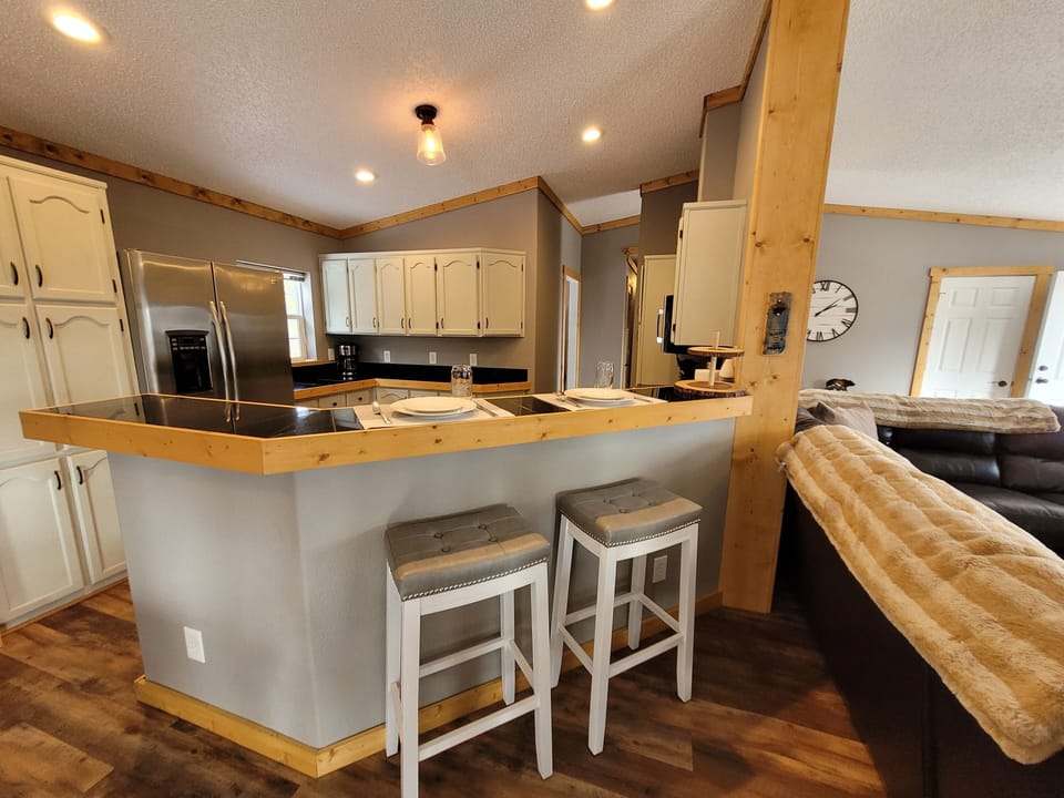 The open-concept kitchen and great room offers bar top seating for 2