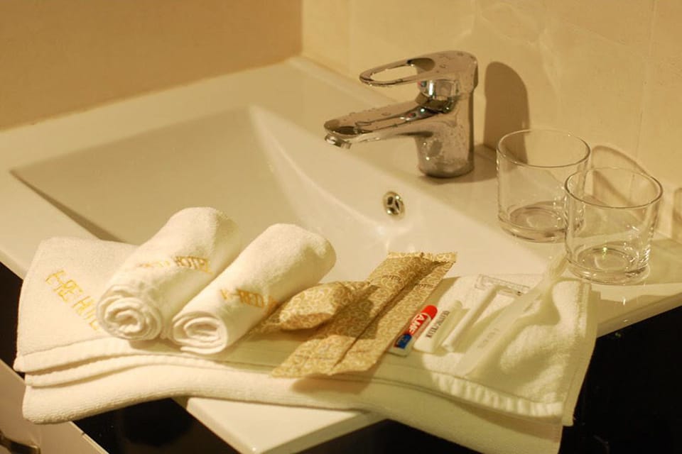 Shower, hair dryer, slippers, towels