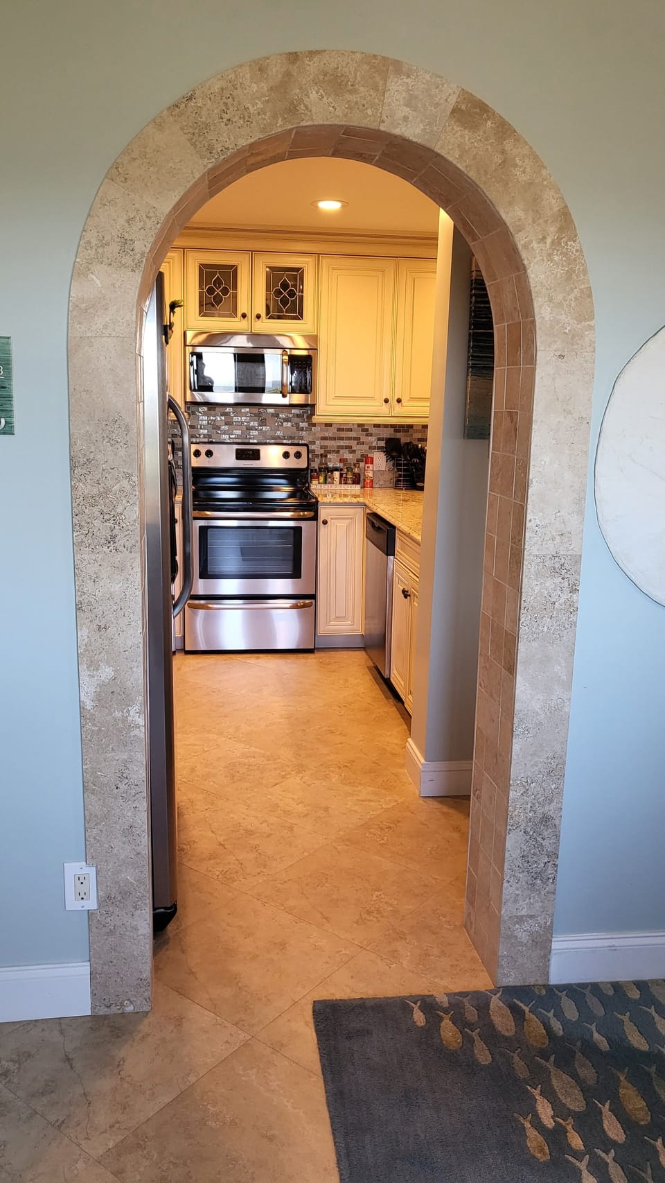 Archway into the fully equipped kitchen