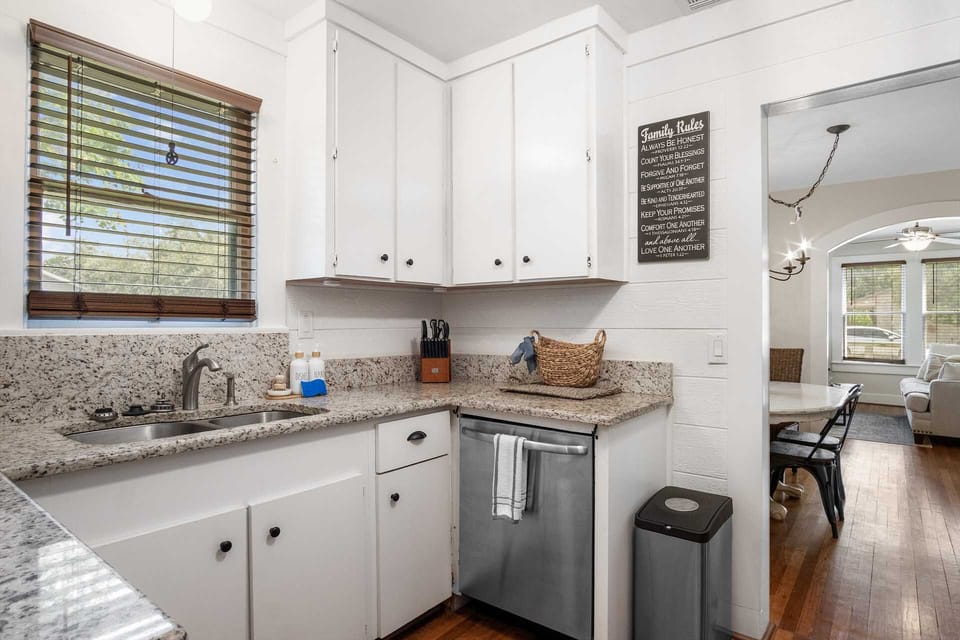 Discover the heart of our home in this fully equipped kitchen, perfect for preparing delicious meals during your stay. Enjoy modern amenities and a seamless flow into the dining area.