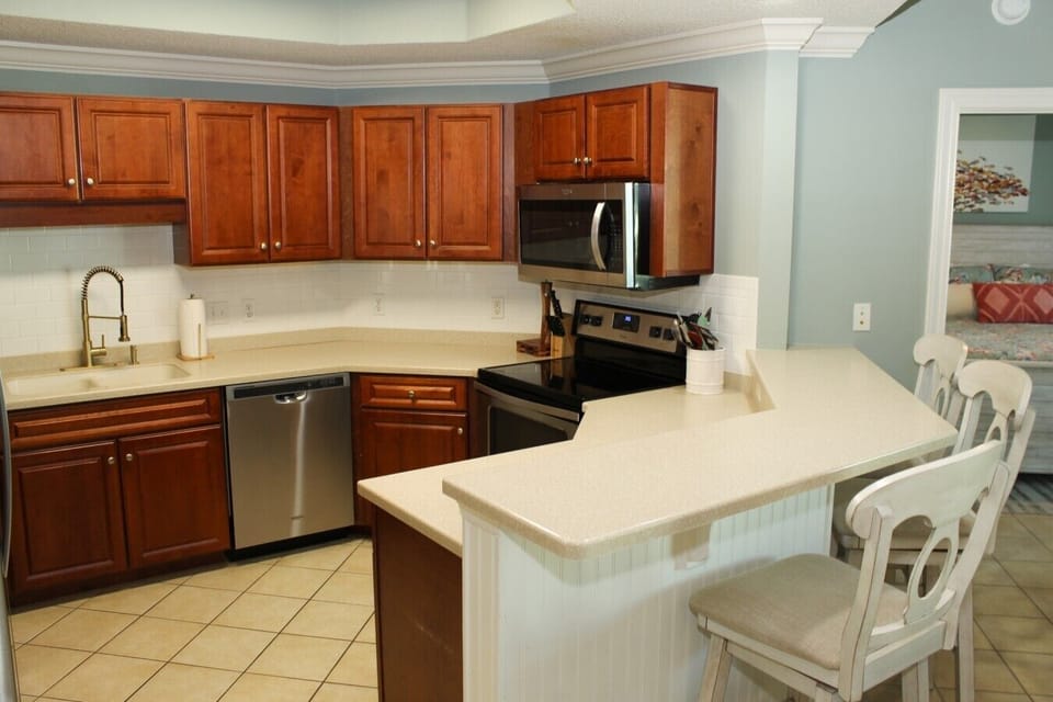 Kitchen with stainless steel appliances and over the range microwave.
