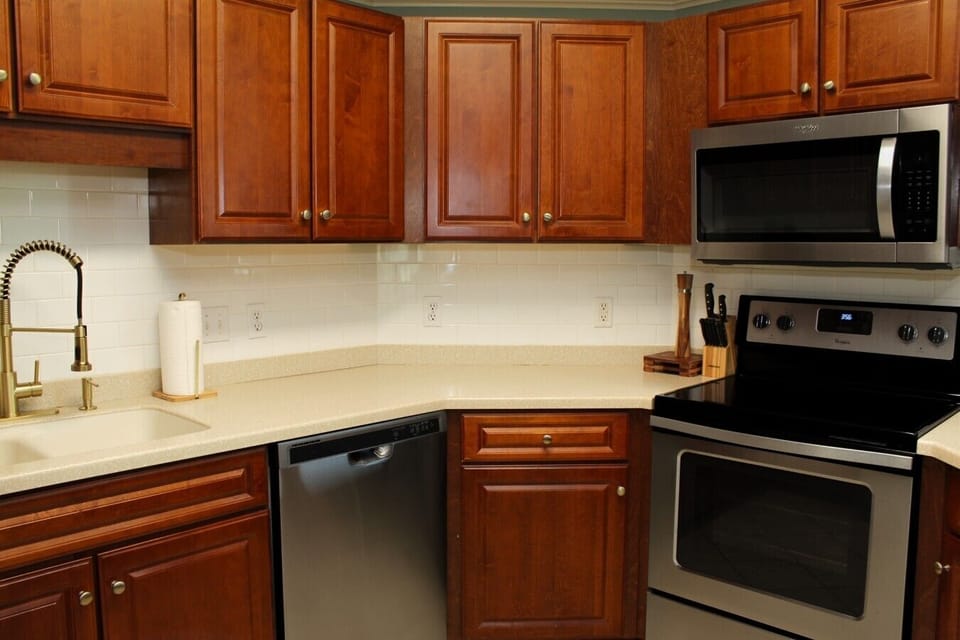 Kitchen with stainless steel appliances and over the range microwave.