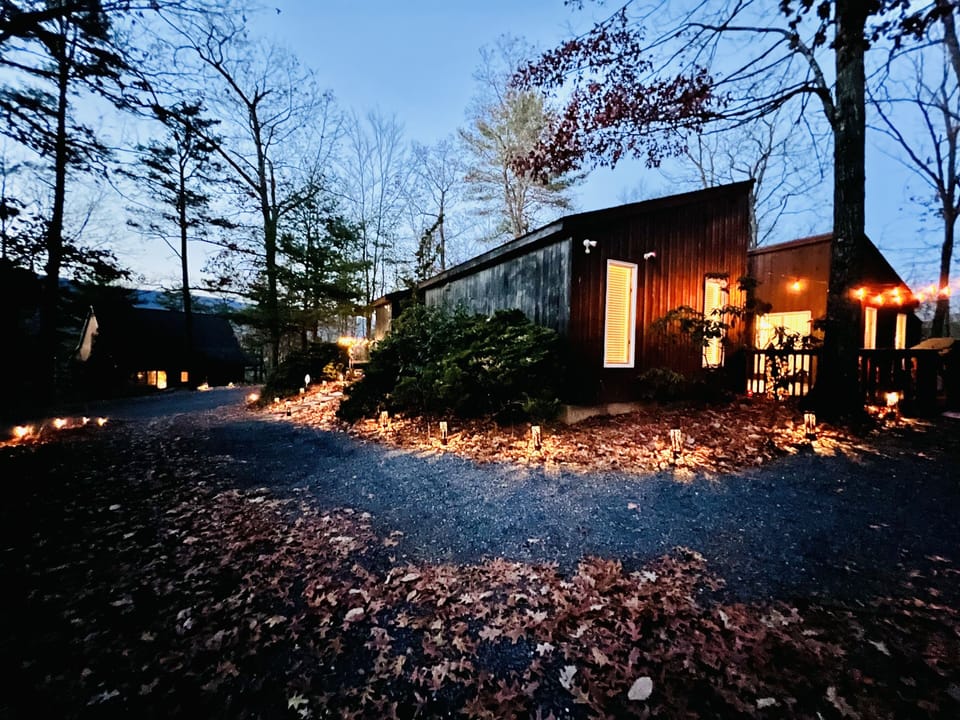View of the driveway/back of the house with mountains in the background.