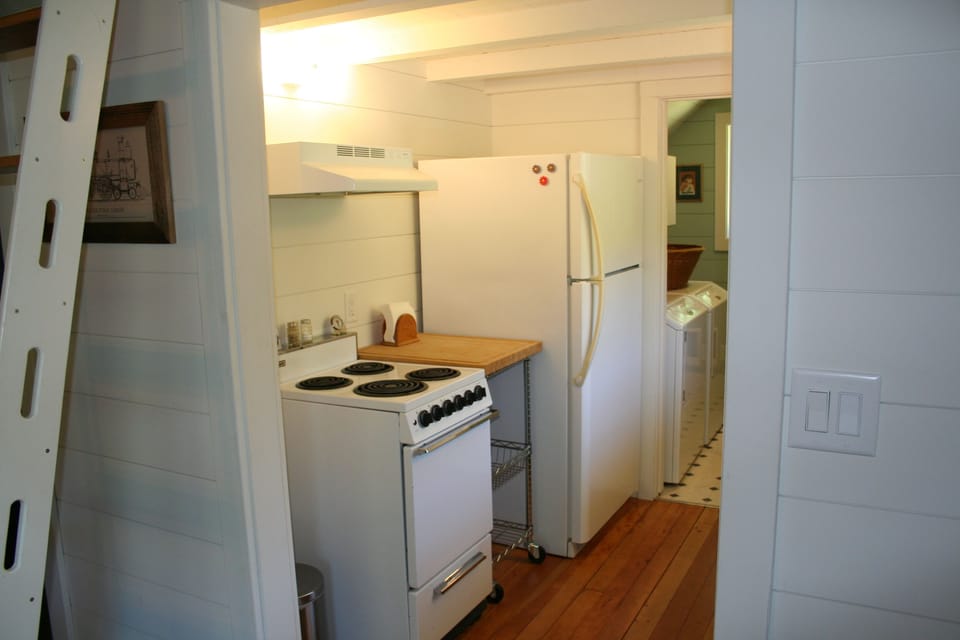 Range with exhaust hood and full sized refrigerator/freezer