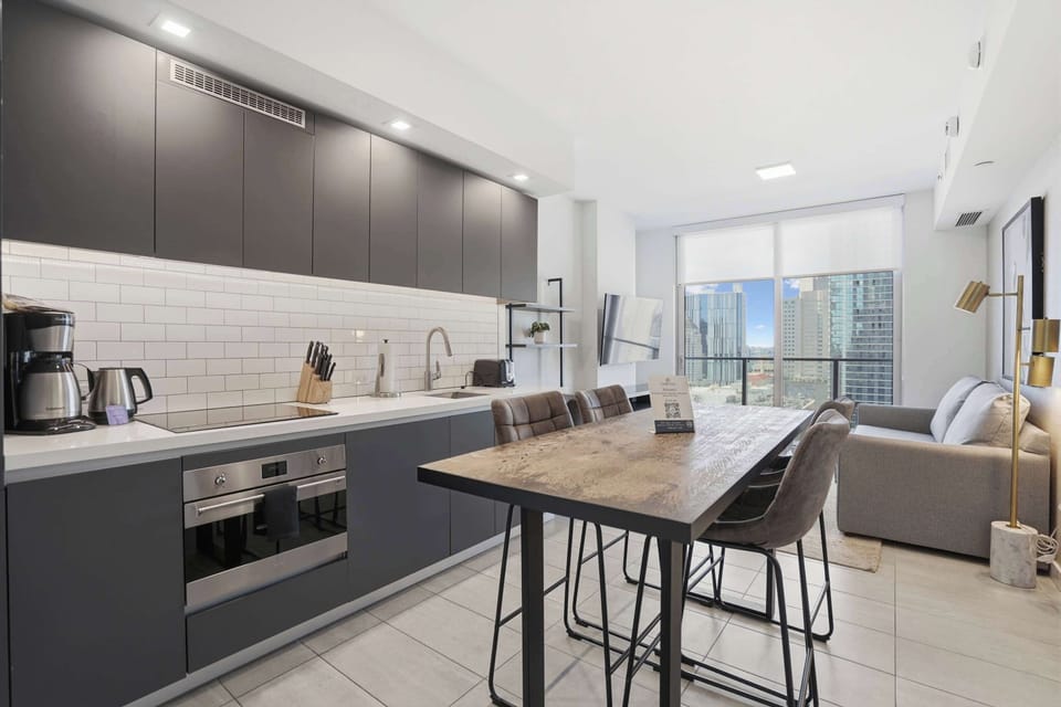 Sleek kitchen with stainless steel appliances and stylish decor.