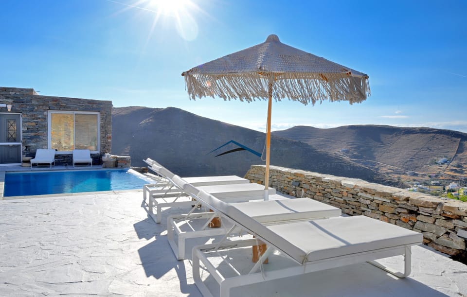 The patios with sunbeds and an umbrella for shade