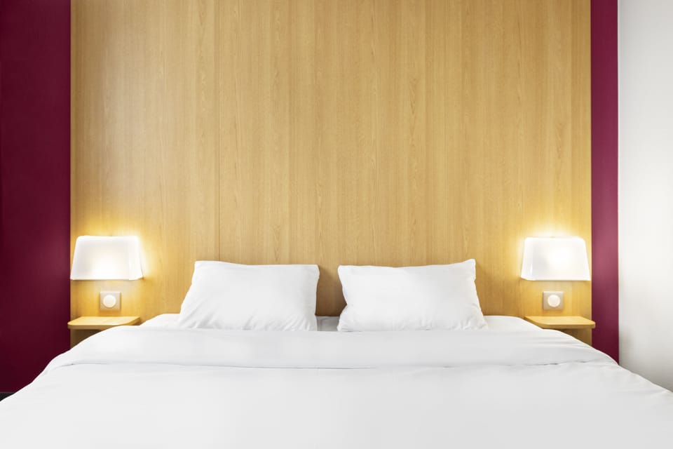 Premium bedding, desk, laptop workspace, blackout drapes