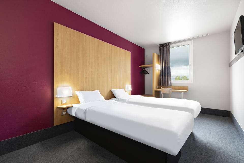 Premium bedding, desk, laptop workspace, blackout drapes