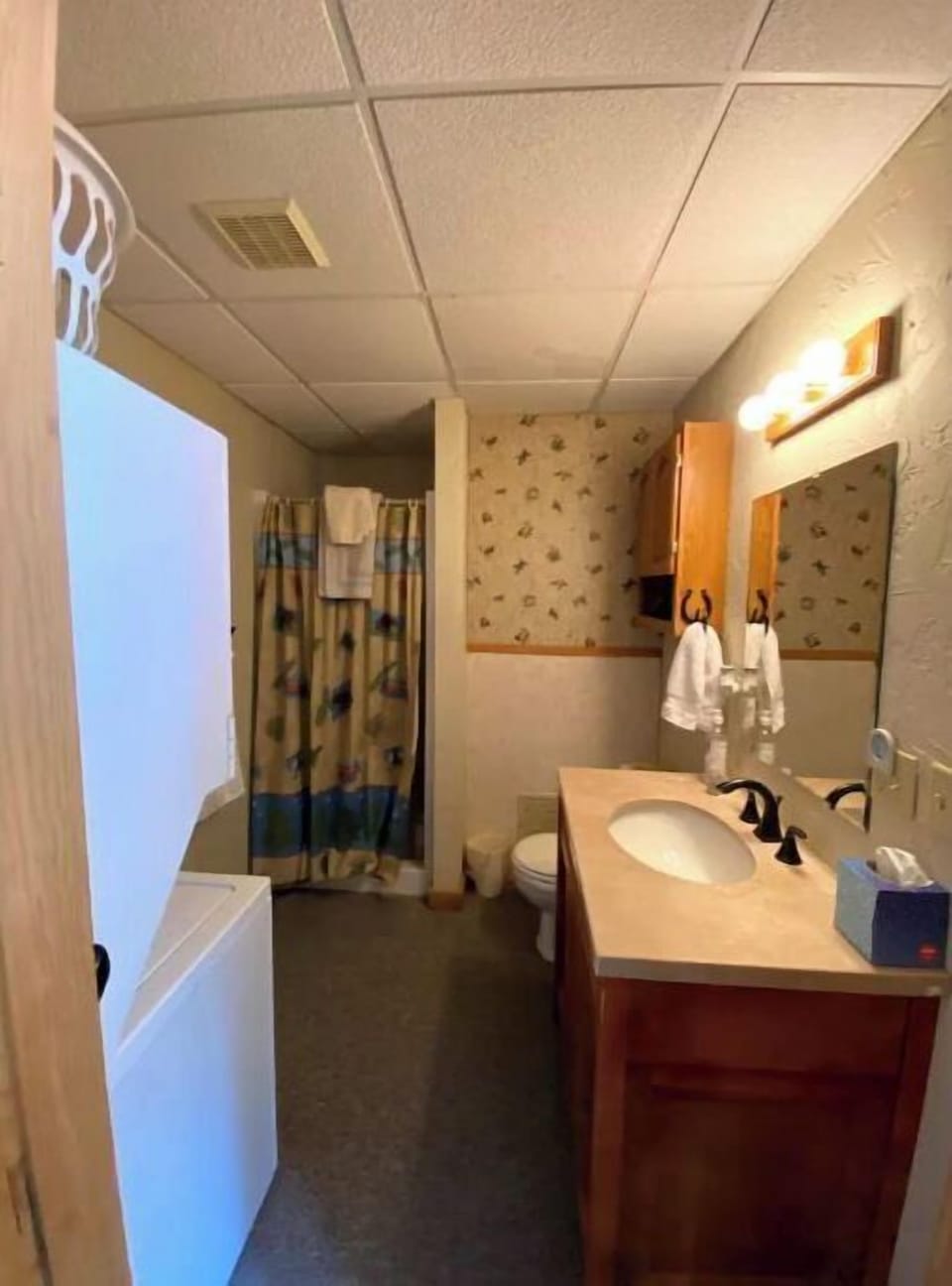 Bathroom has a shower and a stackable washer & dryer. 