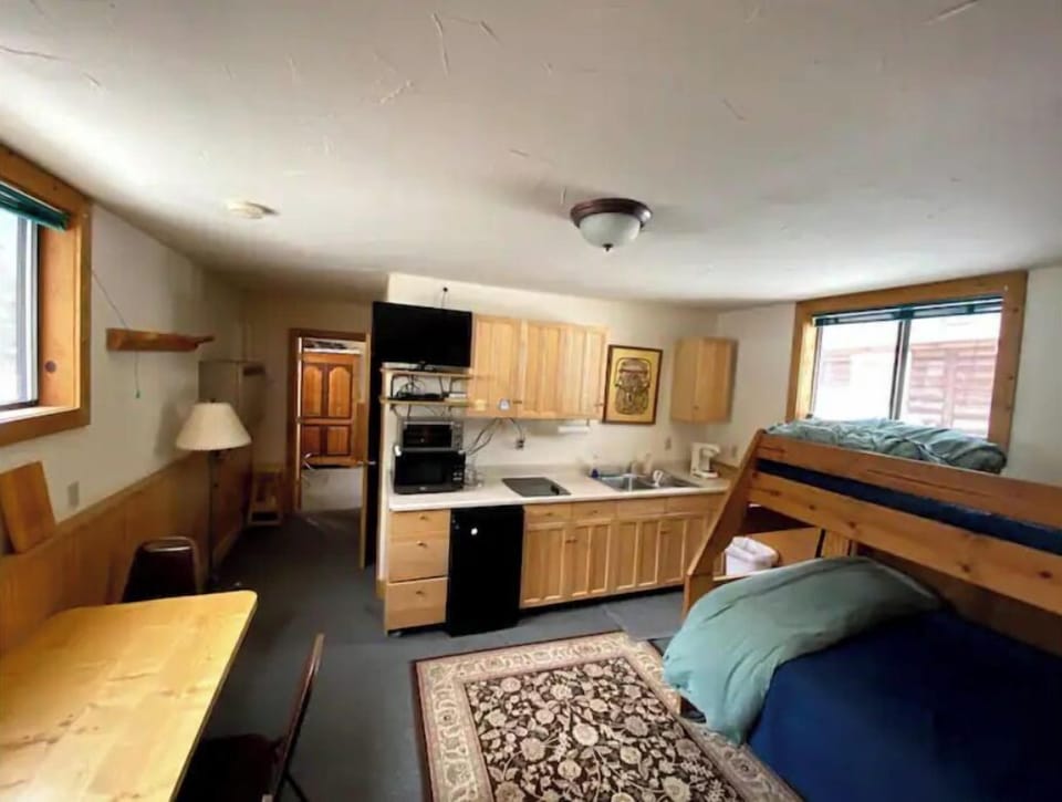 Kitchen w/ fridge, stove, micro, toaster oven.  Twin over double bunk bed. 