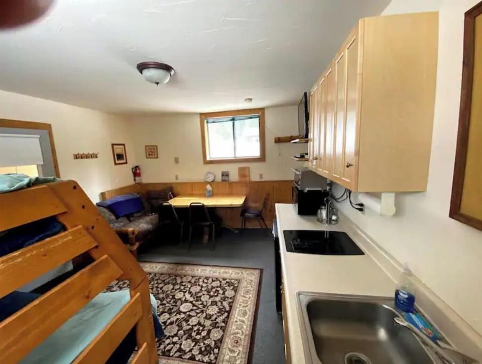 This is the main room with a kitchen, dining table and bunk beds. 