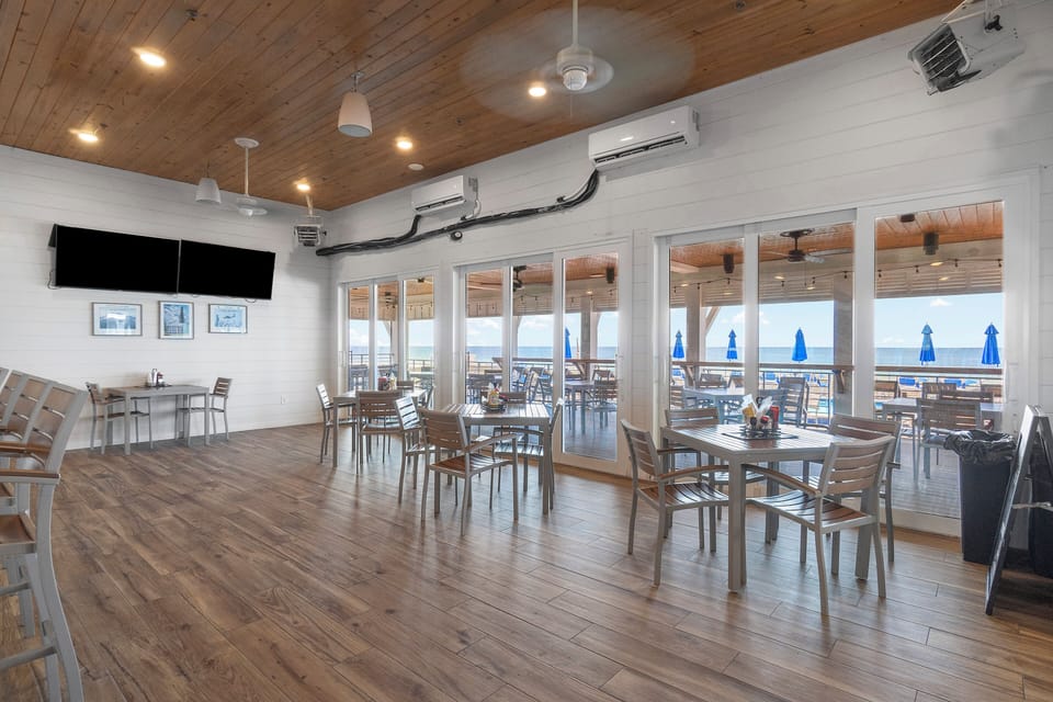 The Lost Key Beach Club This bright communal dining space flows onto an ocean-view deck where blue umbrellas and coastal breezes set the tone for your perfect beach getaway.