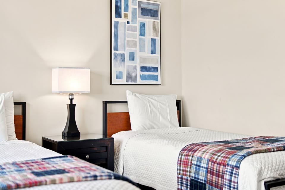 Sandy Key 411- Bright bedroom with two comfortable twin beds dressed in crisp linens and cheerful plaid throws invites restful nights.