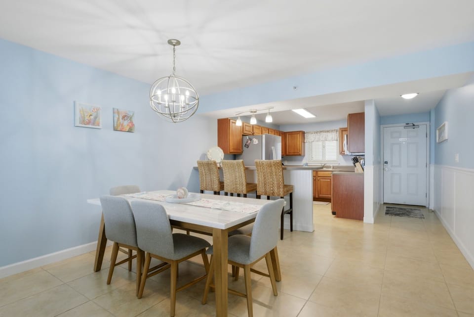 Sandy Key 637- Gather your group around this spacious dining table where memorable meals and laughter come naturally. The open layout flows seamlessly into your fully-equipped kitchen, making hosting effortless.