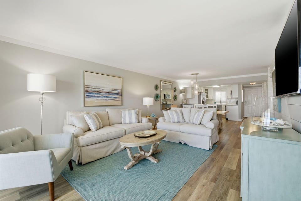 Sandy Key 827- Sink into soft sofas and unwind in your coastal-inspired living space, where natural light and serene colors create the perfect retreat after a day of exploring.