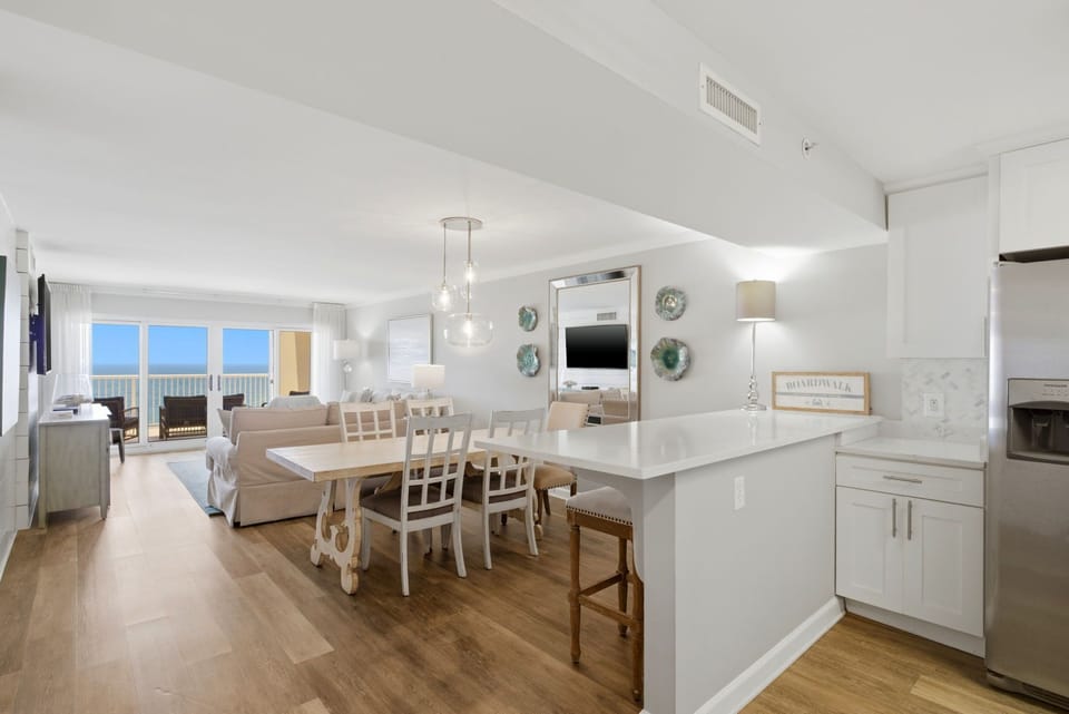 Sandy Key 827- Gather around the dining table with ocean views framing your meals, or relax in the bright living space designed for comfort and connection.