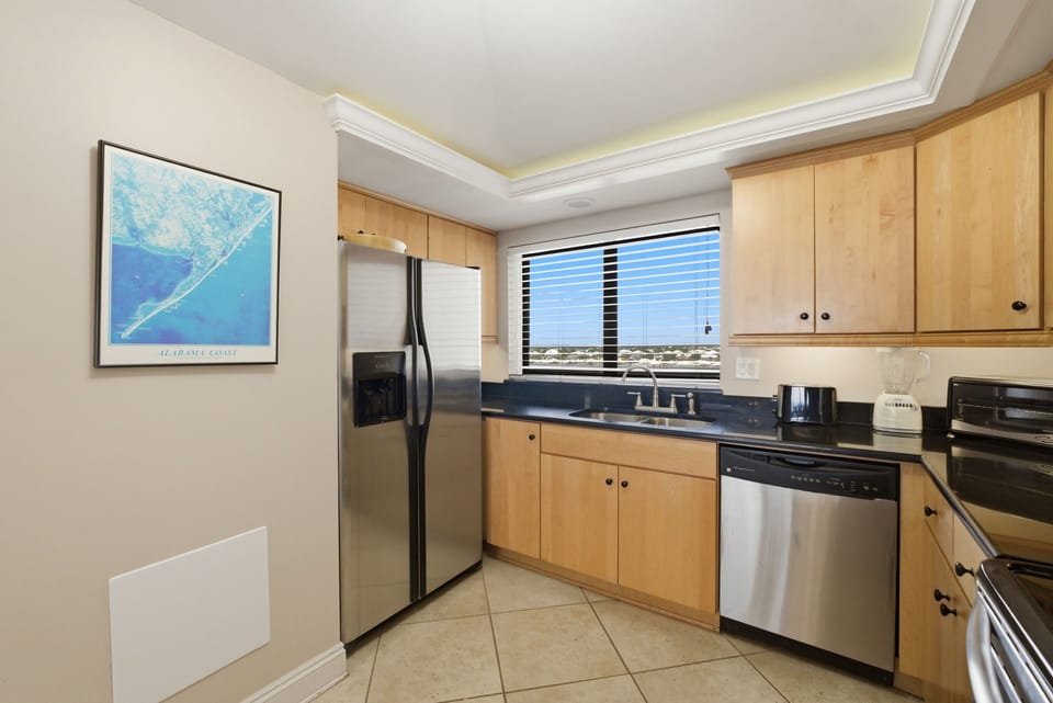 Shipwatch D803- Cook with ease in this fully equipped kitchen featuring stainless steel appliances, ample counter space, and natural light for your culinary adventures.