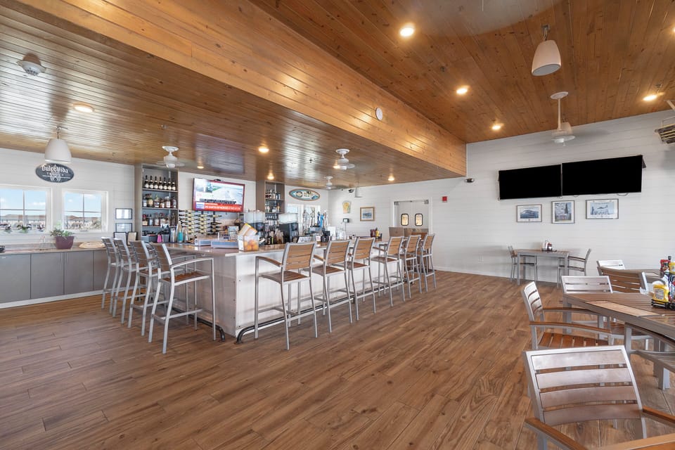 The Lost Key Beach Club A welcoming restaurant and bar space with rustic wood finishes, spacious seating, and natural light perfect for dining and relaxing after your beach adventures.