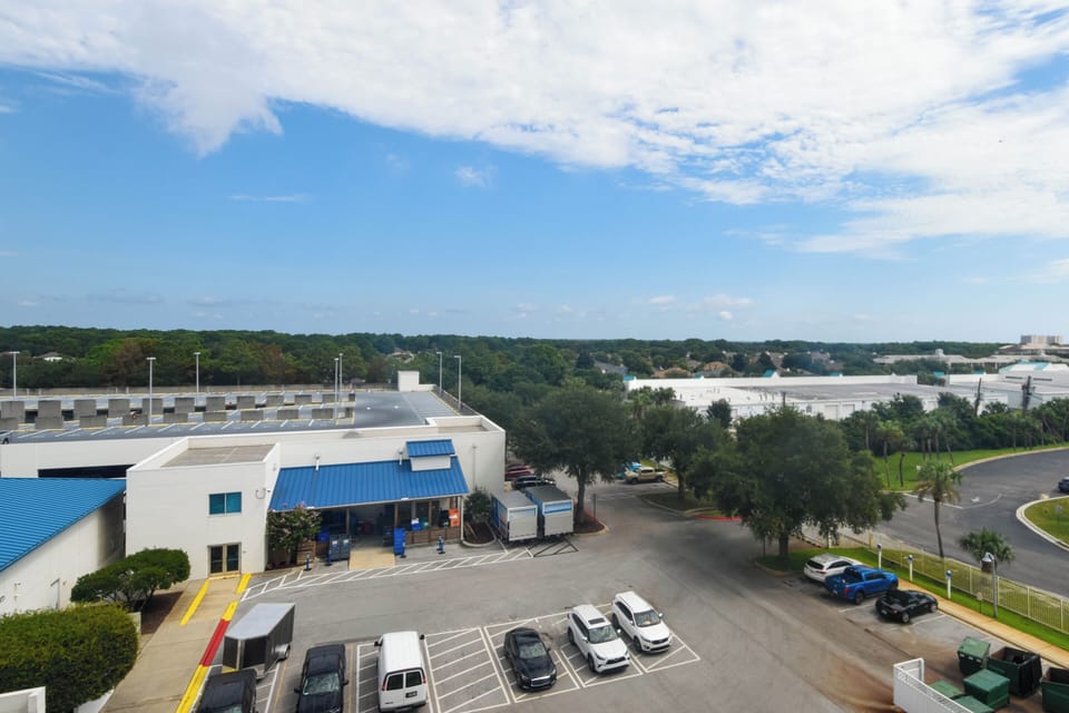 The property is situated in a well-established commercial area surrounded by greenery and neighboring buildings, offering convenient access to local amenities and a peaceful setting.