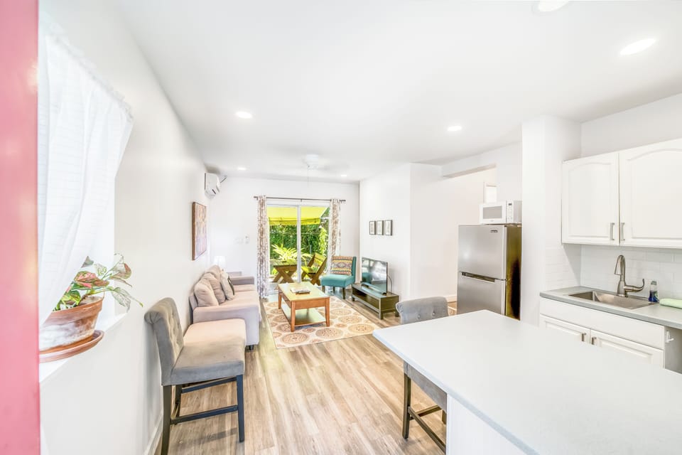 Open plan kitchen, living, dining. Bar seats two. 