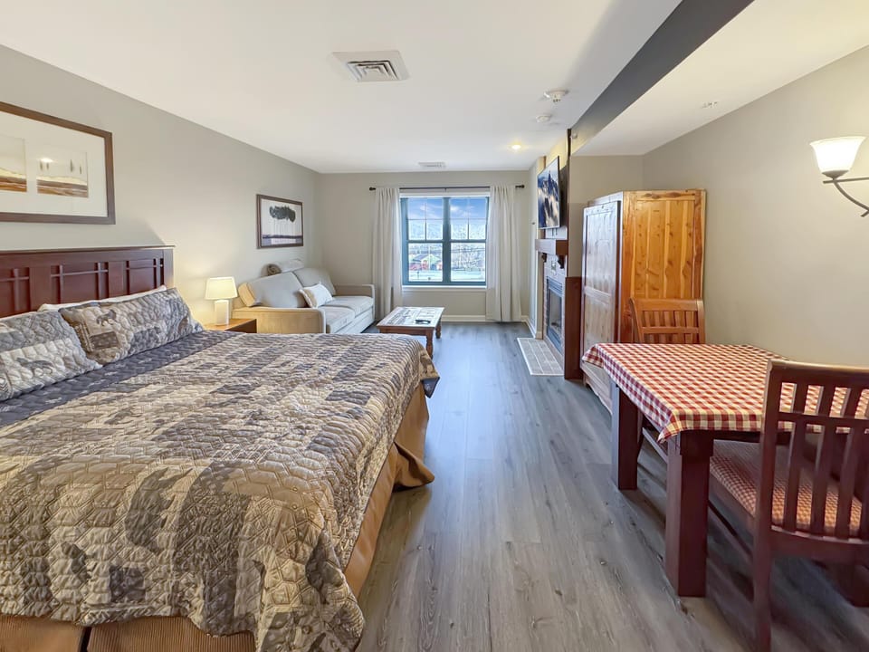 Spacious bedroom retreat with cozy seating and dining area