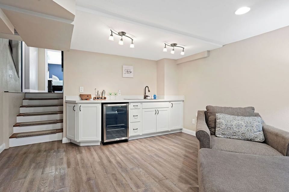 Basement wet bar with mini fridge.