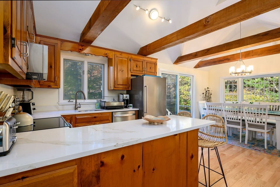 View of kitchen and dining areas from hallway entry