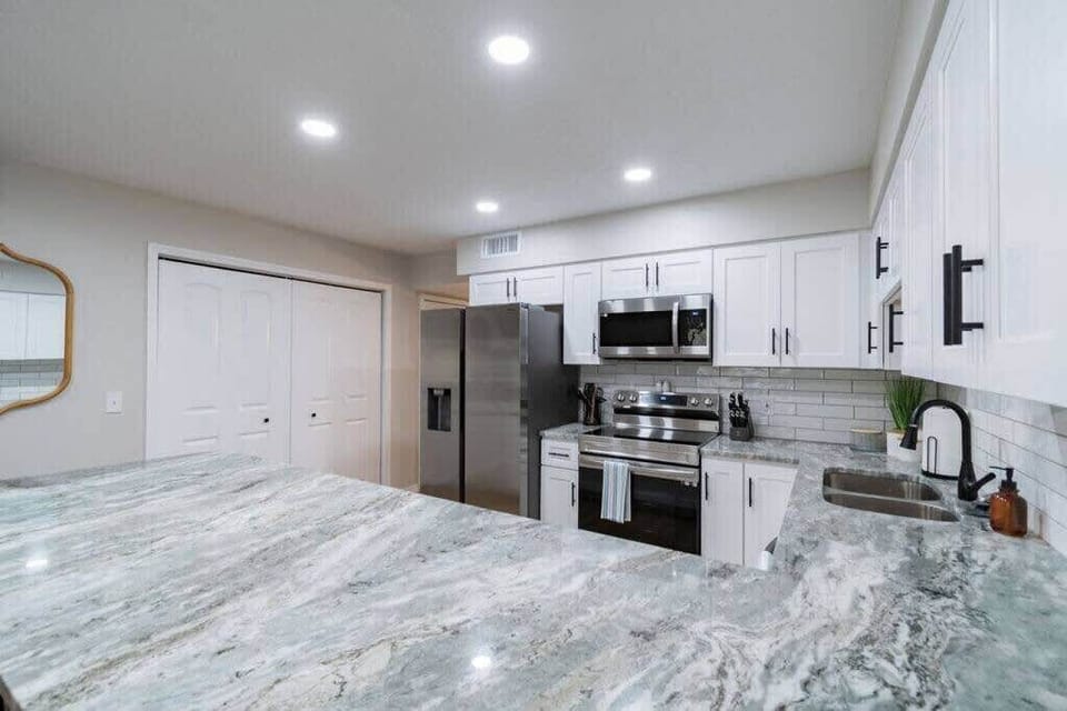 Modern kitchen with stainless steel appliances and granite countertops
