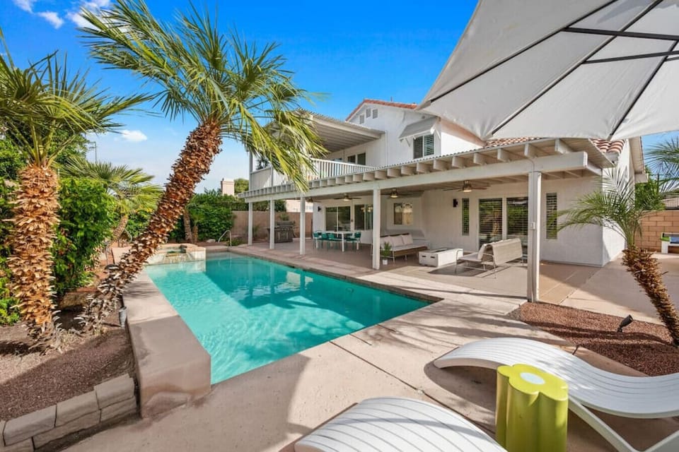 Private backyard: sun chaises with umbrella