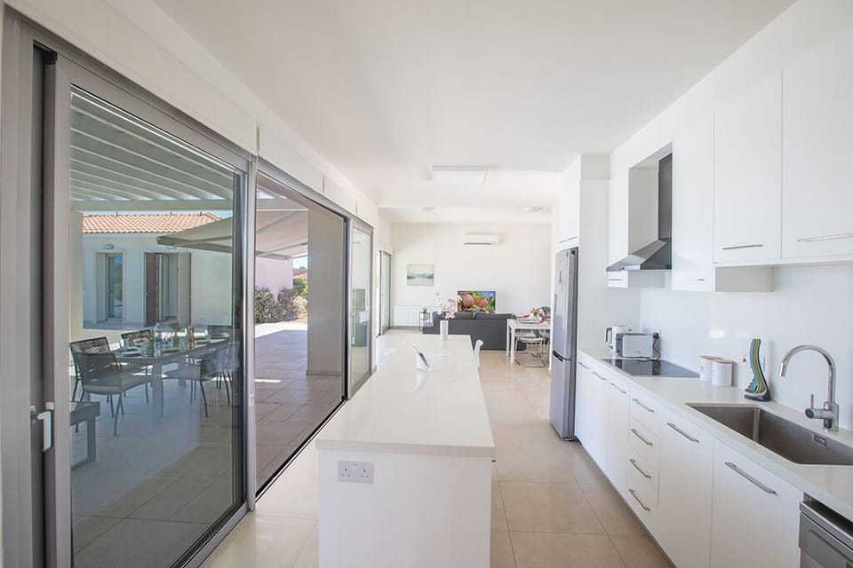 Open-Plan surrounded by large patio doors leading to the garden and pool