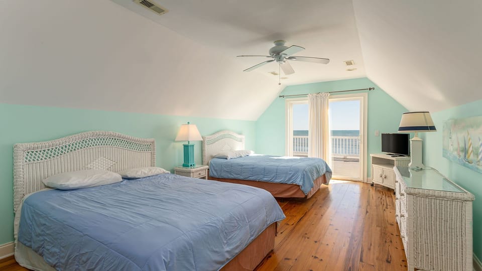 Drift off in your bright, airy loft bedroom with two beds, ocean breeze from your private balcony, and soothing coastal colors throughout.