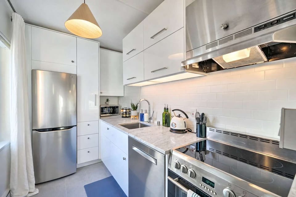 Stylish kitchen with sleek appliances, clean design, and a welcoming space to prepare meals.