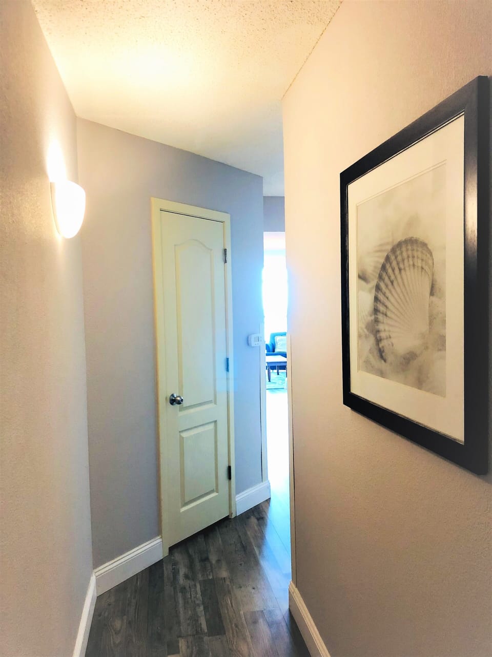 Hallway that opens to a bright, airy space