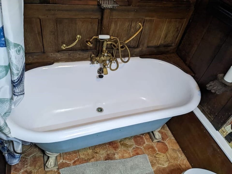 cast iron bath in panelled bathroom 