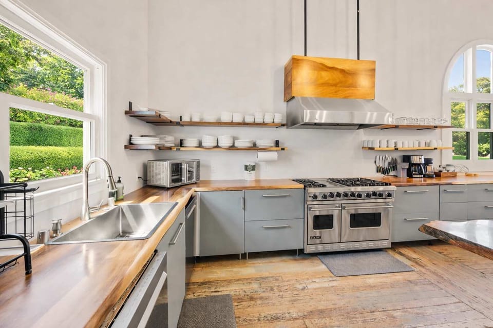 Modern Chef’s Kitchen with Premium Appliances, Open Shelving, and Natural Light — Clean, Functional, and Beautifully Designed