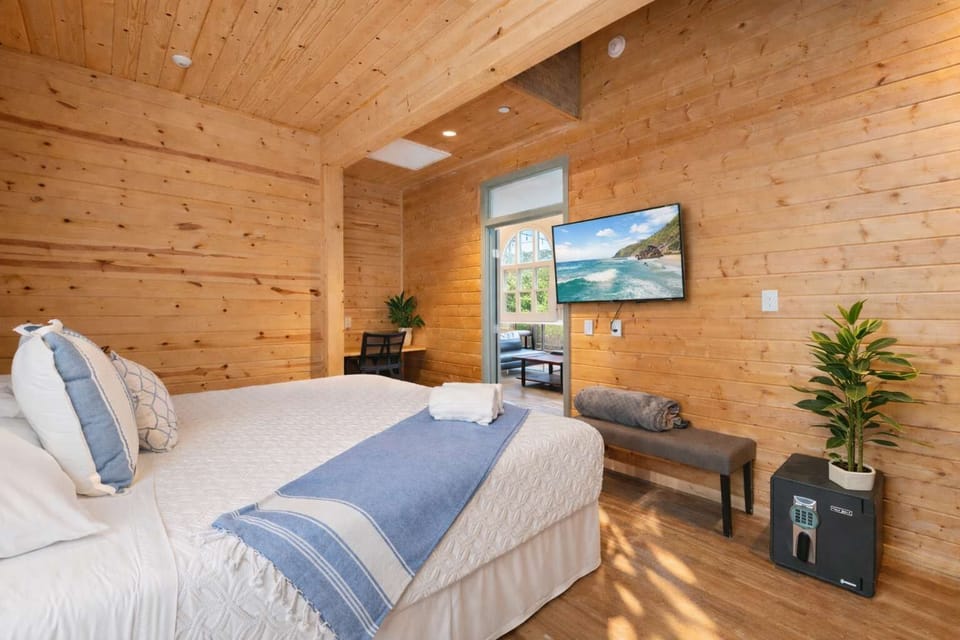Private Bedroom with Wood Interior, Comfortable Bed, Smart TV, and Natural Light — Warm, Quiet, and Designed for Rest

