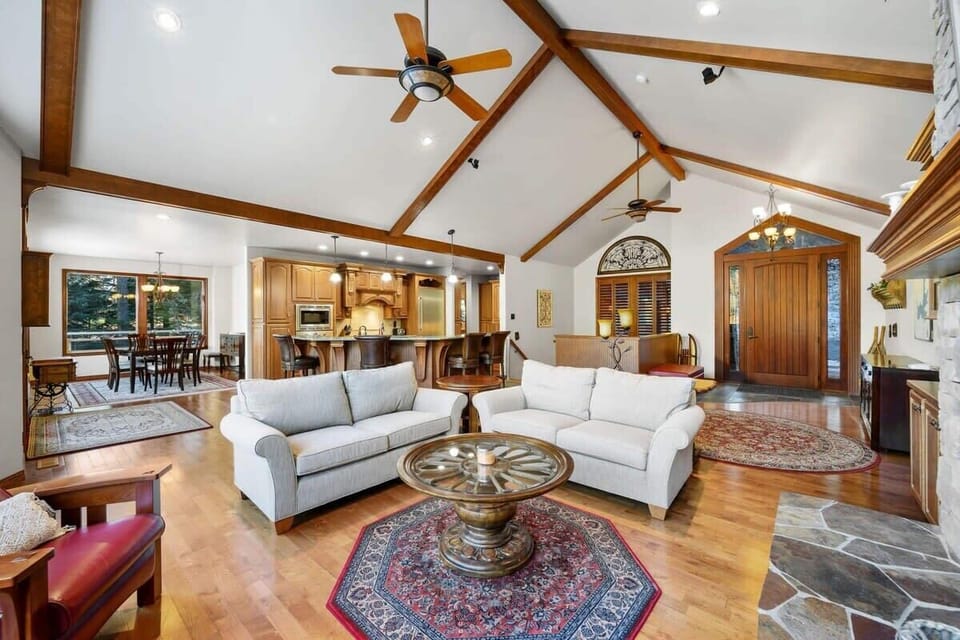 Unwind in this stunning open-concept living space with vaulted ceilings, exposed beams, and luxury furnishings creating your perfect mountain retreat.