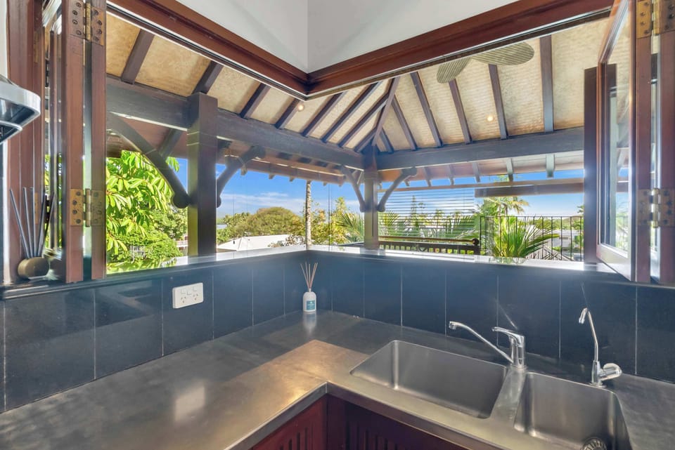 Prepare breakfast in the kitchen while wide-opening windows frame leafy tropical outlooks and invite fresh breezes throughout the space.