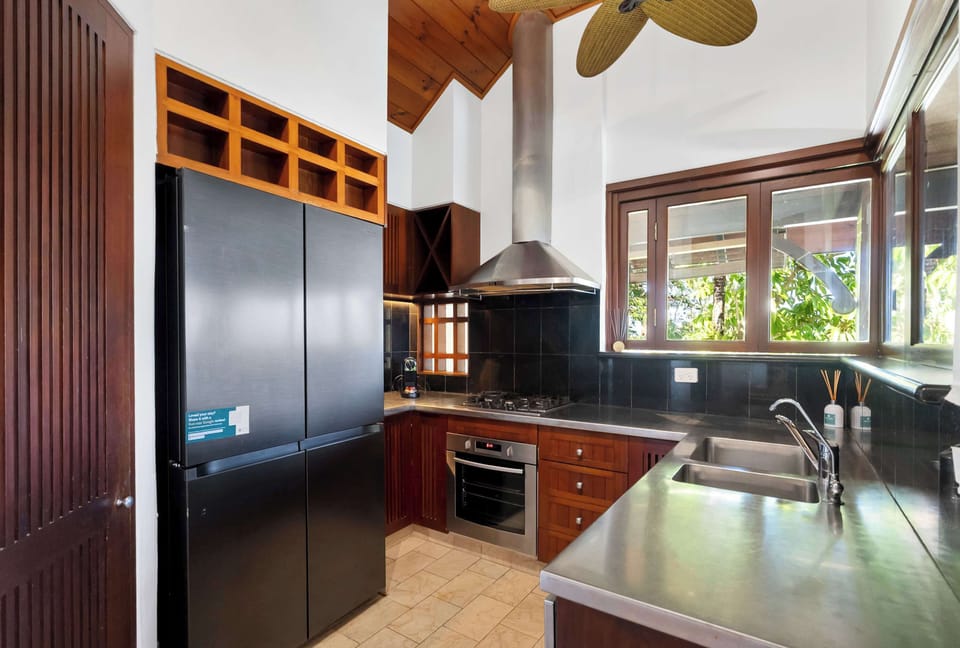 Cook with ease in the kitchen, where generous bench space, quality appliances and soaring ceilings make holiday dining feel effortless.