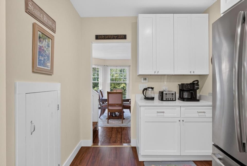 The dining room is located off of the kitchen and comfortably seats six