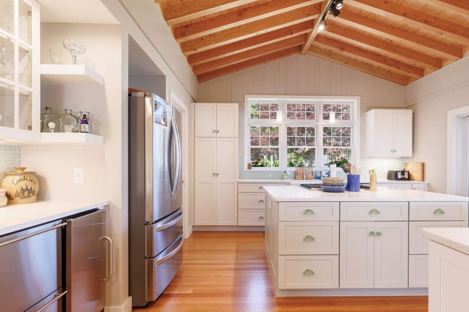 Large kitchen with beautiful granite countertops, steel appliances, and large island